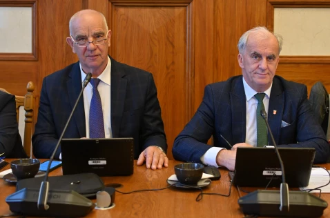 Radni Piotr Goraj i Krzysztof Gębala siedzą przy laptopach w sali sesyjnej