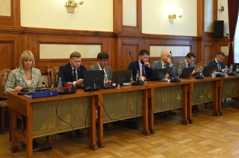 Radni Powiatu siedzą przy biurkach w sali sesyjnej